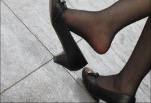 Orange high heels and dangling legs